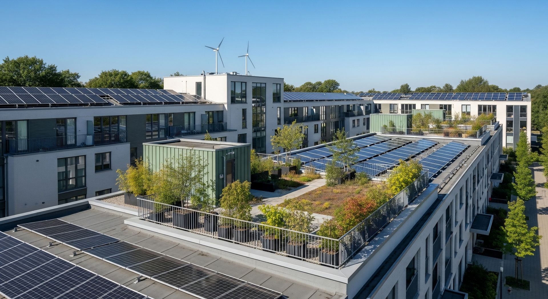 Immeubles d'appartements modernes avec panneaux solaires sur le toit et terrasses verdoyantes sous un ciel bleu azur.