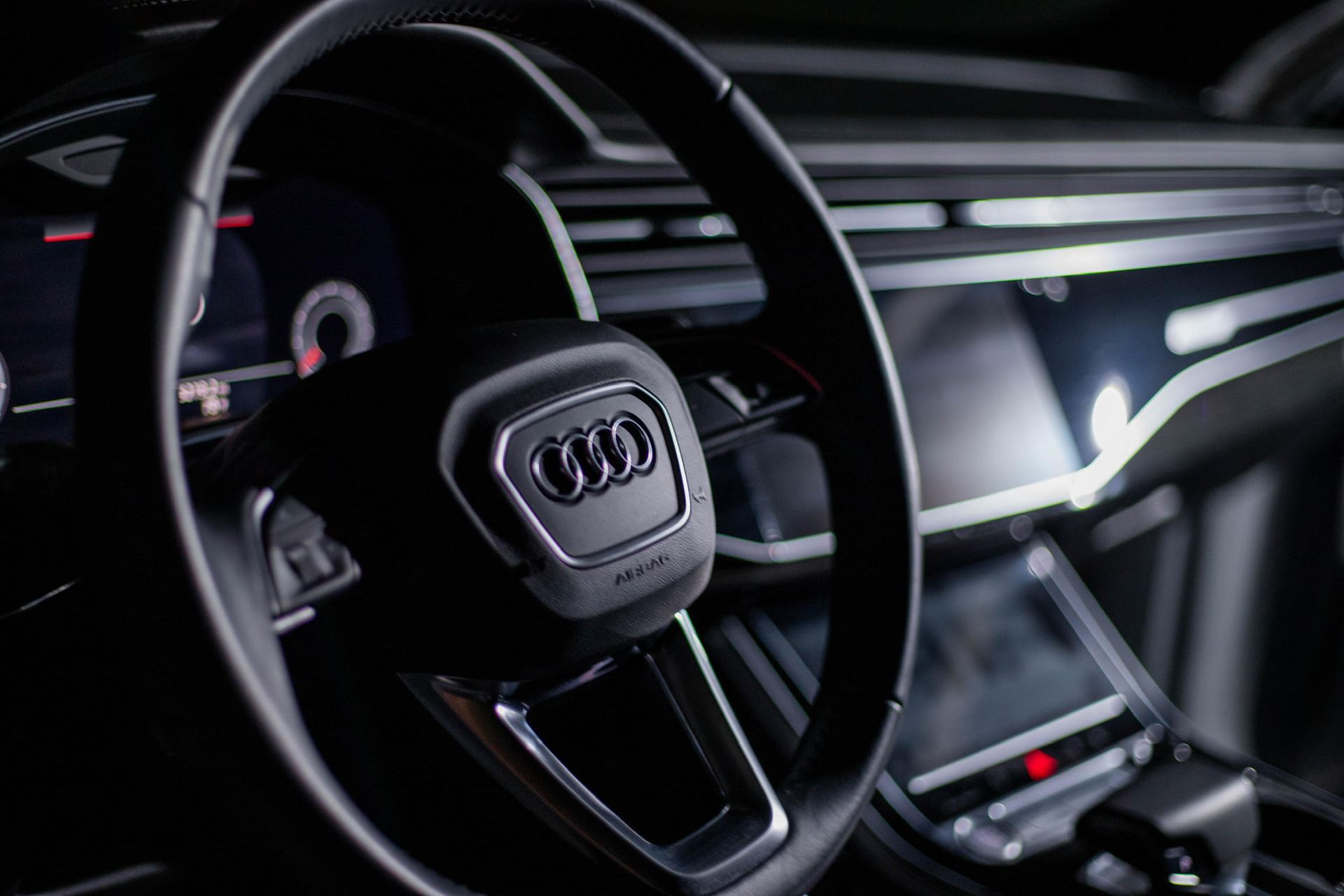 A close up of a steering wheel in a car.