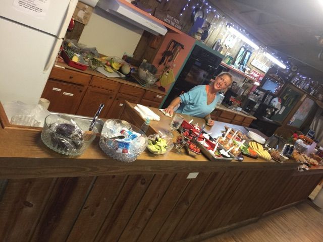 A woman is standing behind a counter in a kitchen