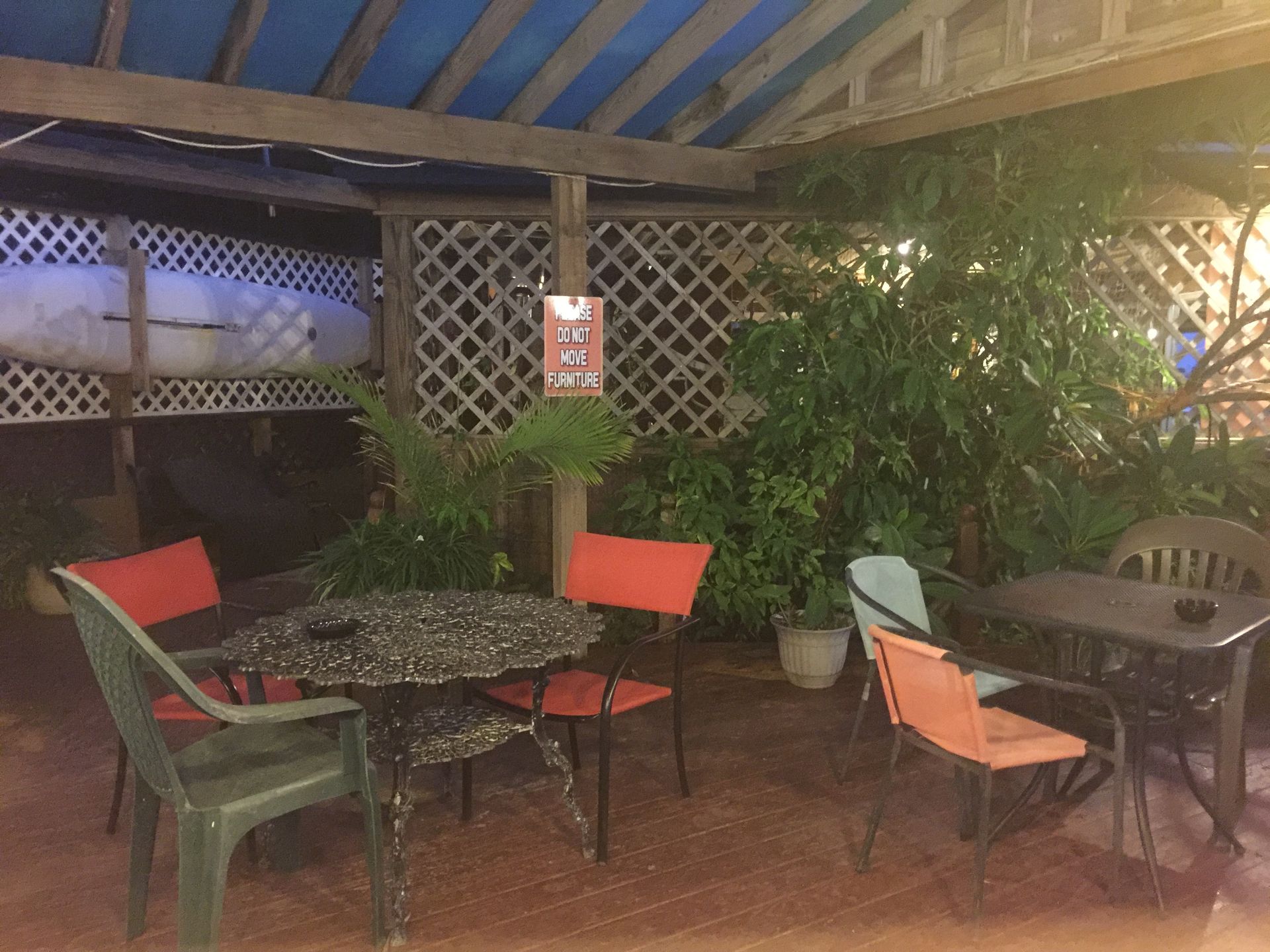 A patio with tables and chairs and a sign that says do not enter