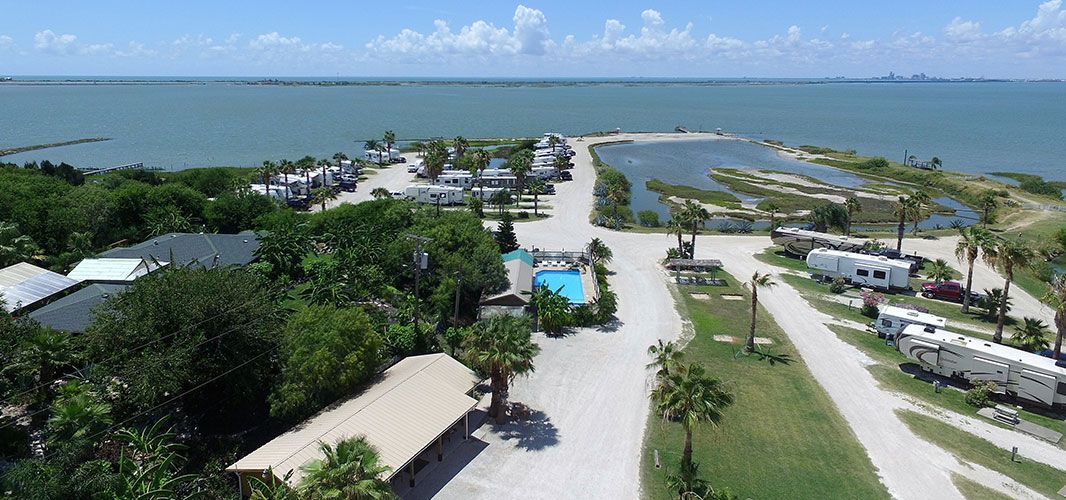 An aerial view of a campground next to a body of water.