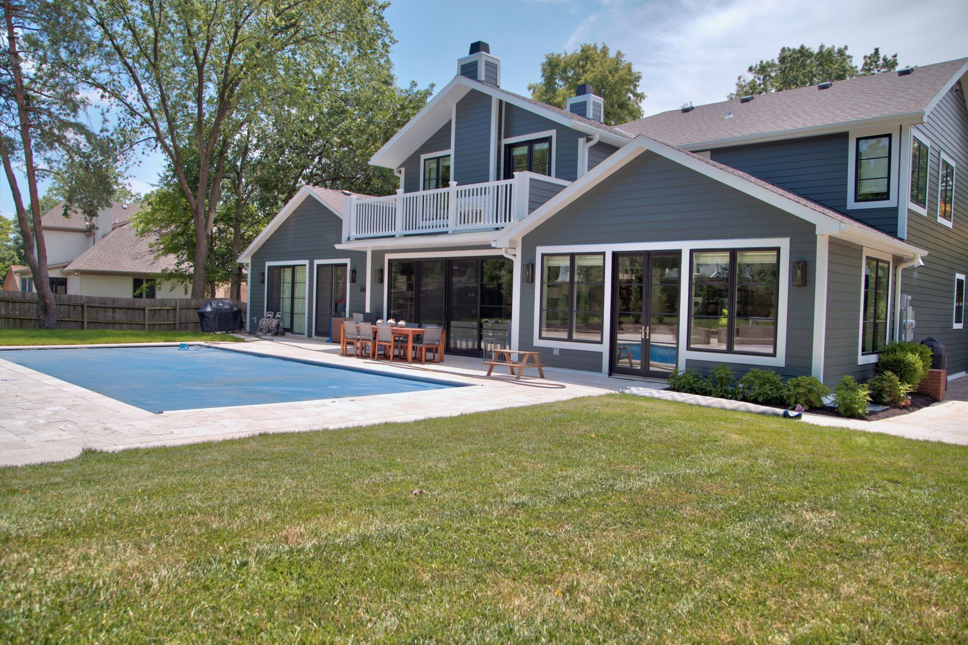 A large house with a large swimming pool in the backyard.