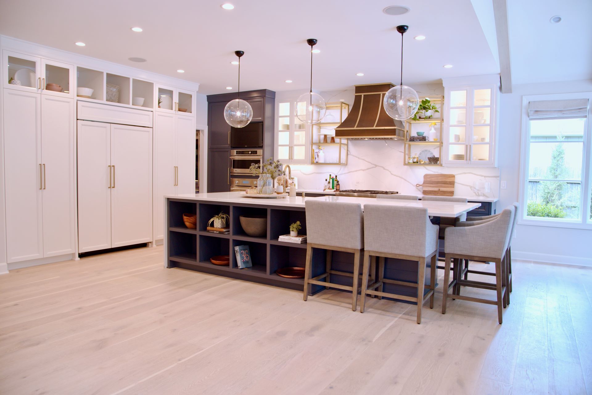 A large kitchen with a large island and stools.