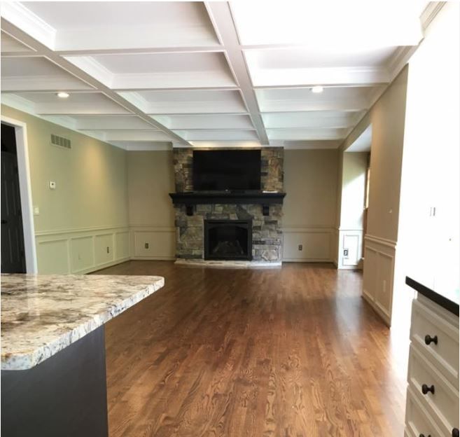 A living room with a fireplace and a flat screen tv