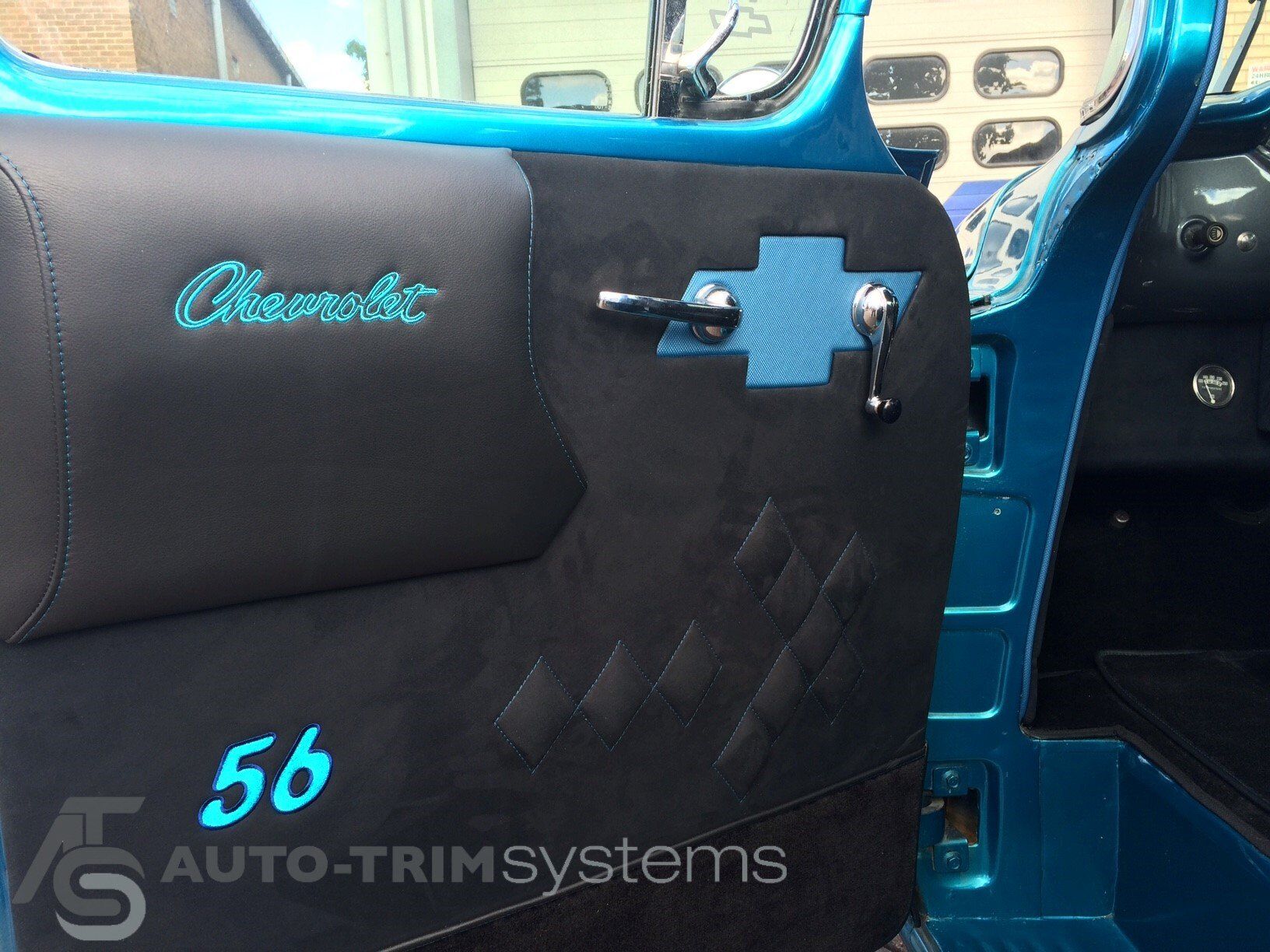 Modified '56 Chevrolet Pick-Up with custom doorcard with diamond-stitching and embroidered logos