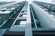 Looking up at modern high-rise apartment buildings with balconies and windows