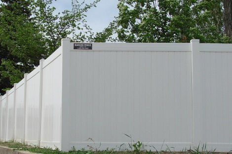 A white fence with a sign on it that says ' safety first '