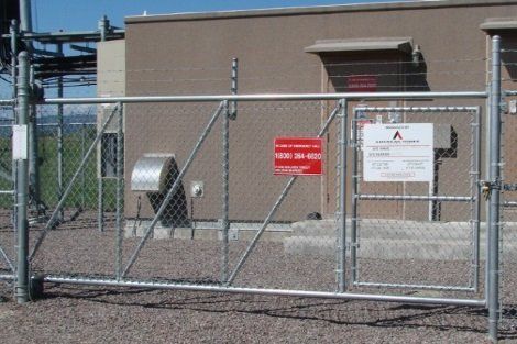 A chain link fence with a red sign on it