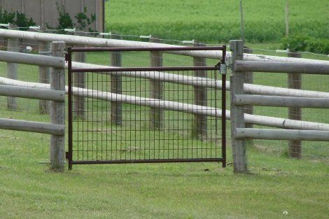 A fence with a gate in the middle of it