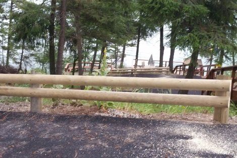 A wooden fence with trees in the background