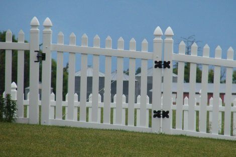 A white picket fence with a black gate
