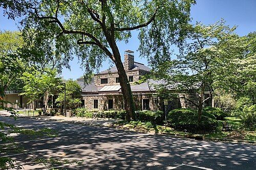 An image of the Scarsdale, NY public library, with trees.