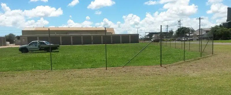 A Pickup Truck on a Grassy Field — Tableland Self Storage In Atherton, QLD