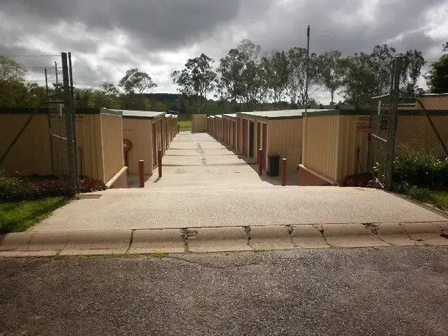 A Concrete Path Leads Between Rows of Small — Tableland Self Storage In Atherton, QLD
