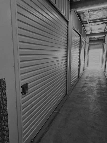 Storage Units Lined in a Dim Corridor — Tableland Self Storage In Atherton, QLD