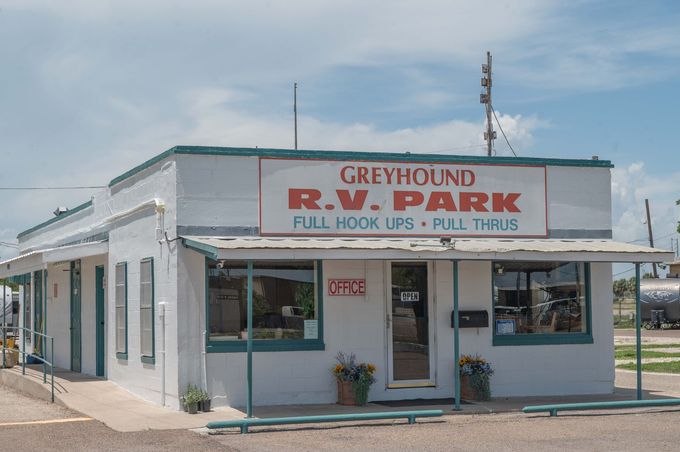 Small white building labeled “Greyhound R.W. Park” with a covered porch in a rural setting