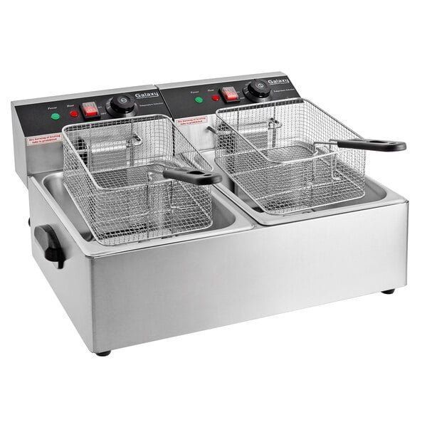 A stainless steel deep fryer with two baskets on a white background.