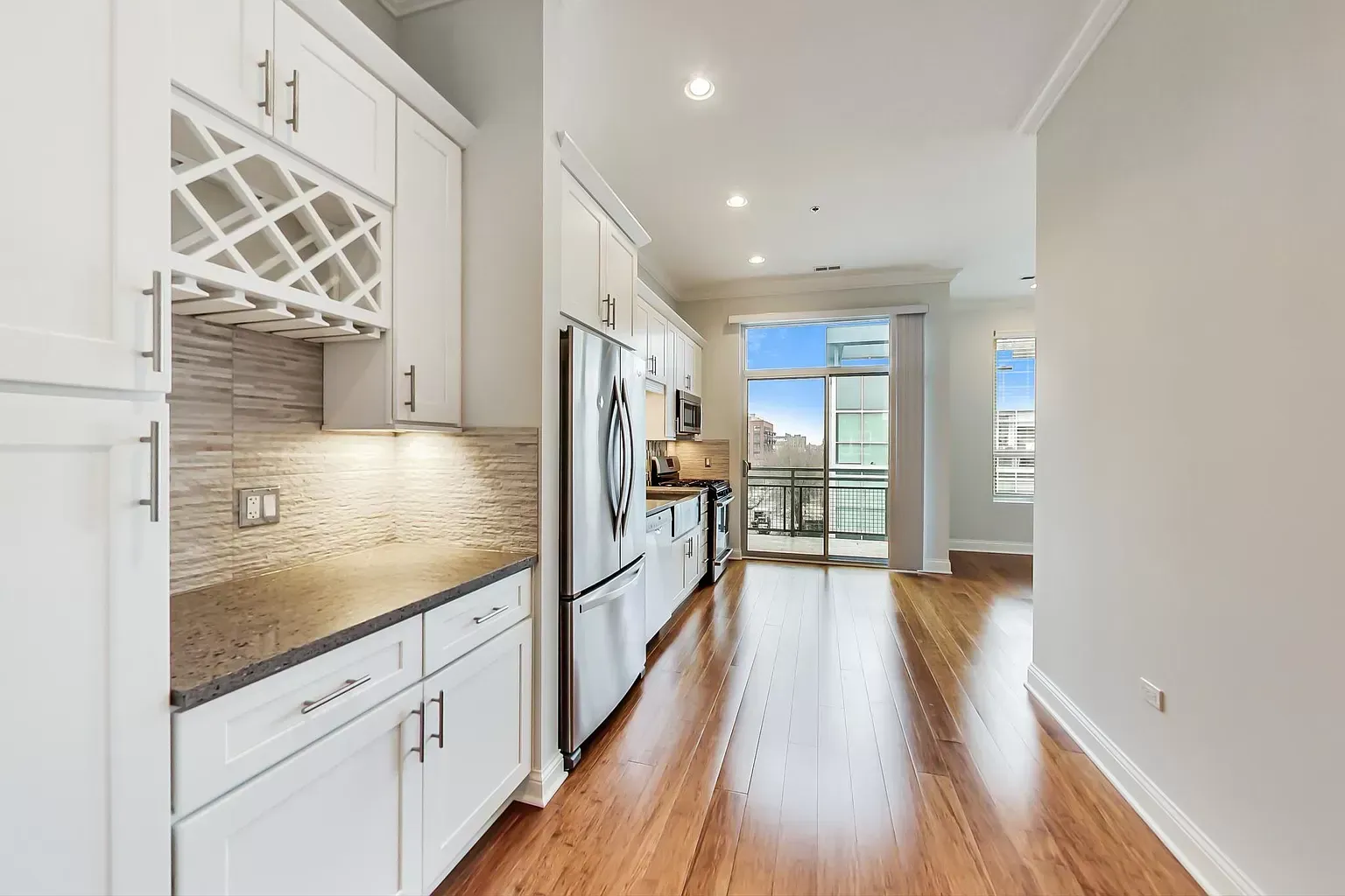 a kitchen with white cabinets and stainless steel appliances