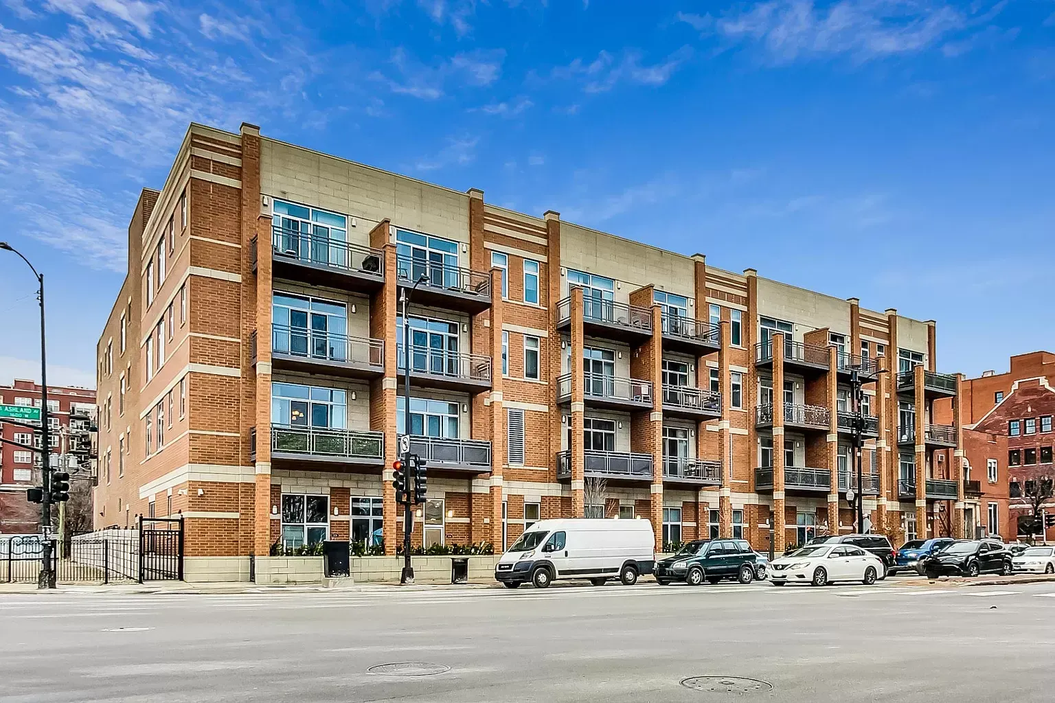 a large brick building with cars parked in front of it .