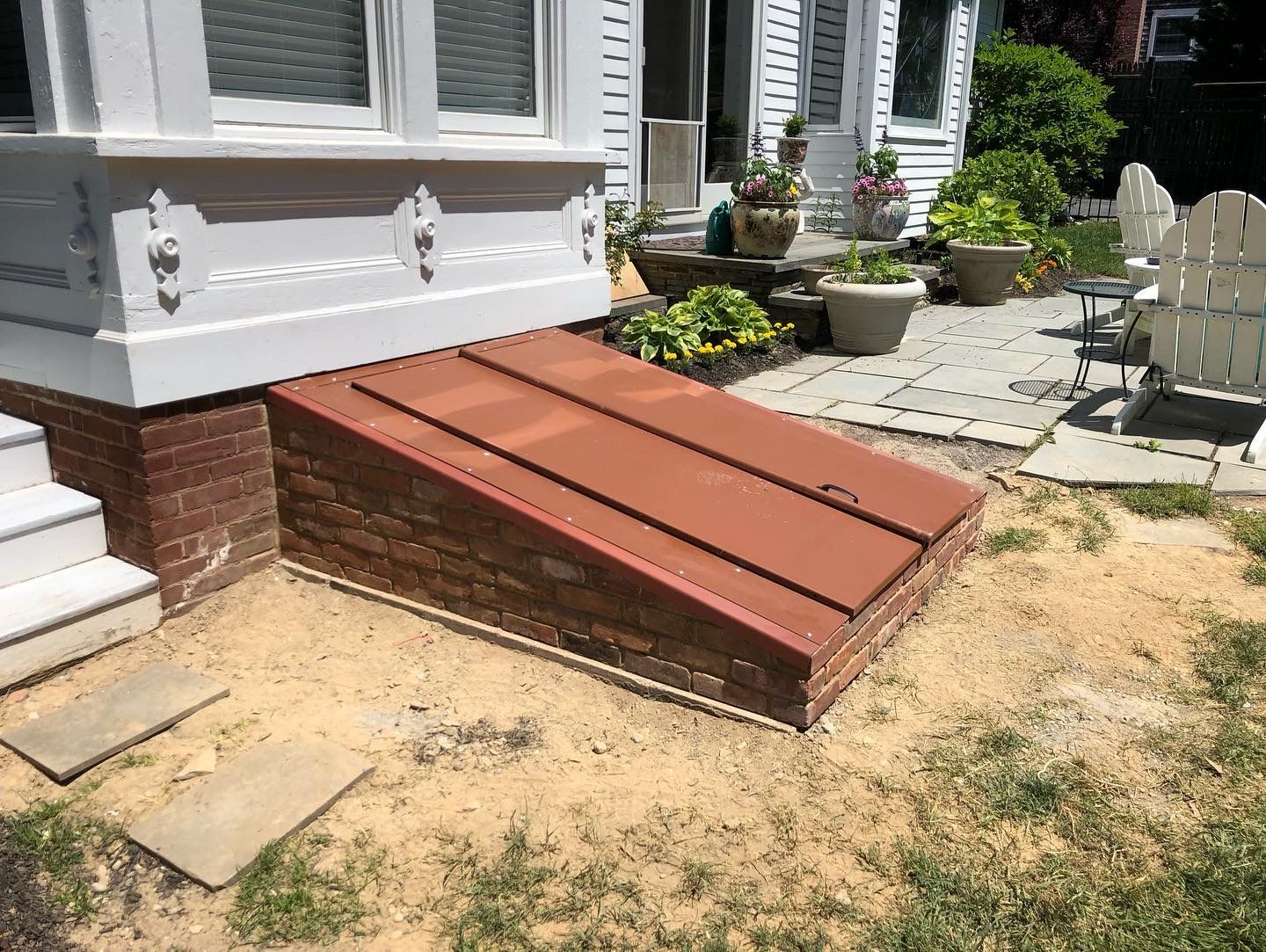 A brick ramp is being built in front of a house.