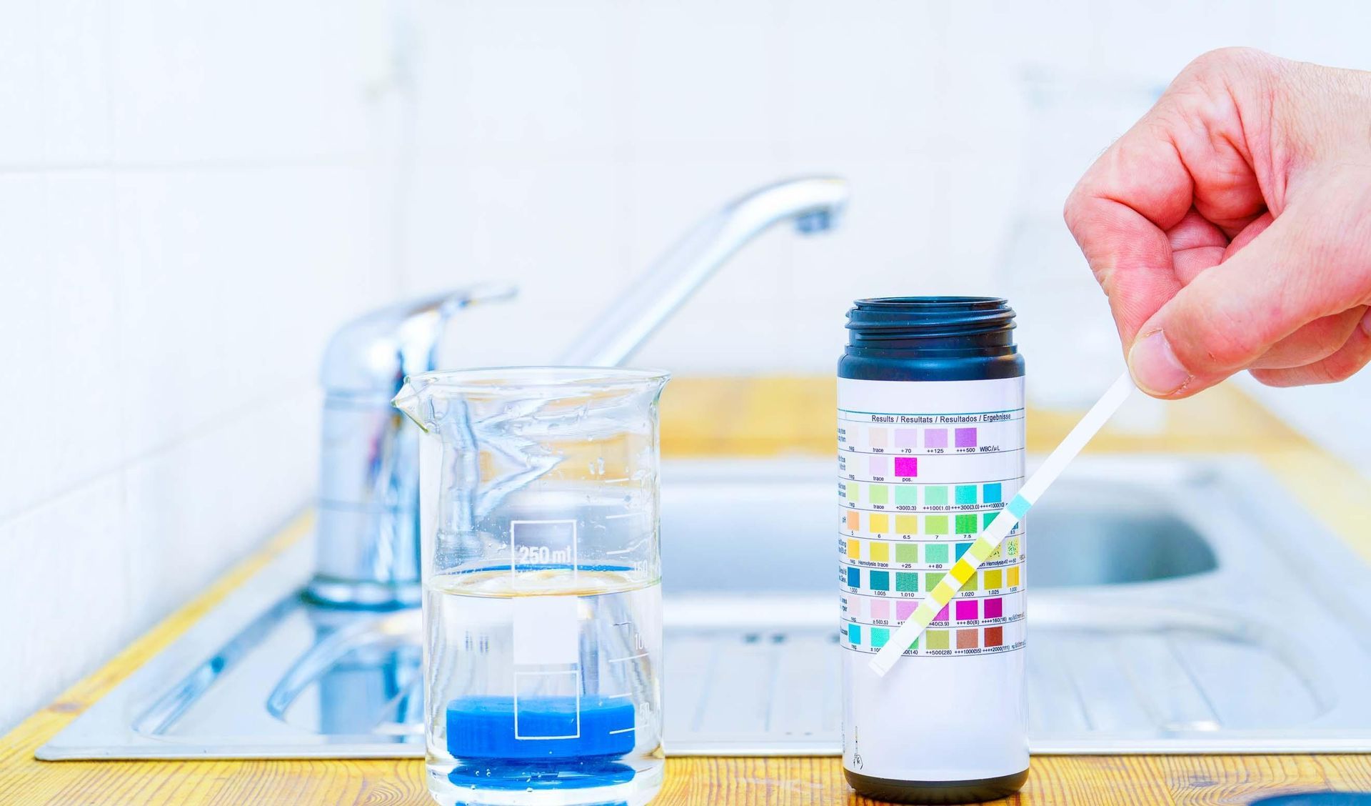 a person is taking a sample of water from a bottle