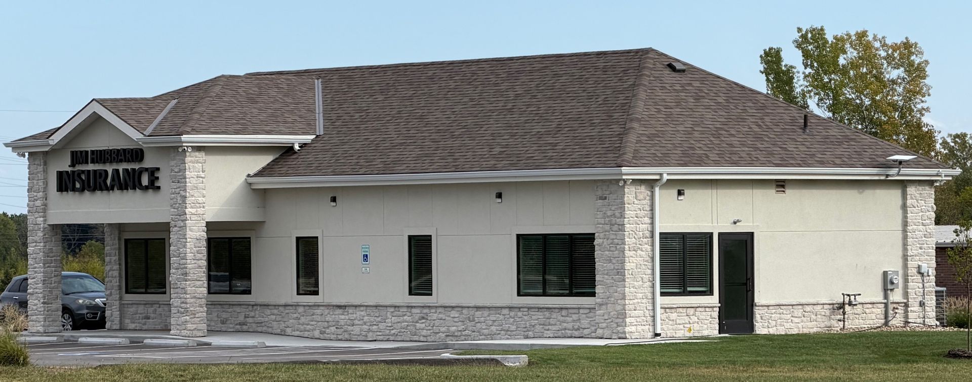 Exterior of a modern medical office building with stone and beige siding