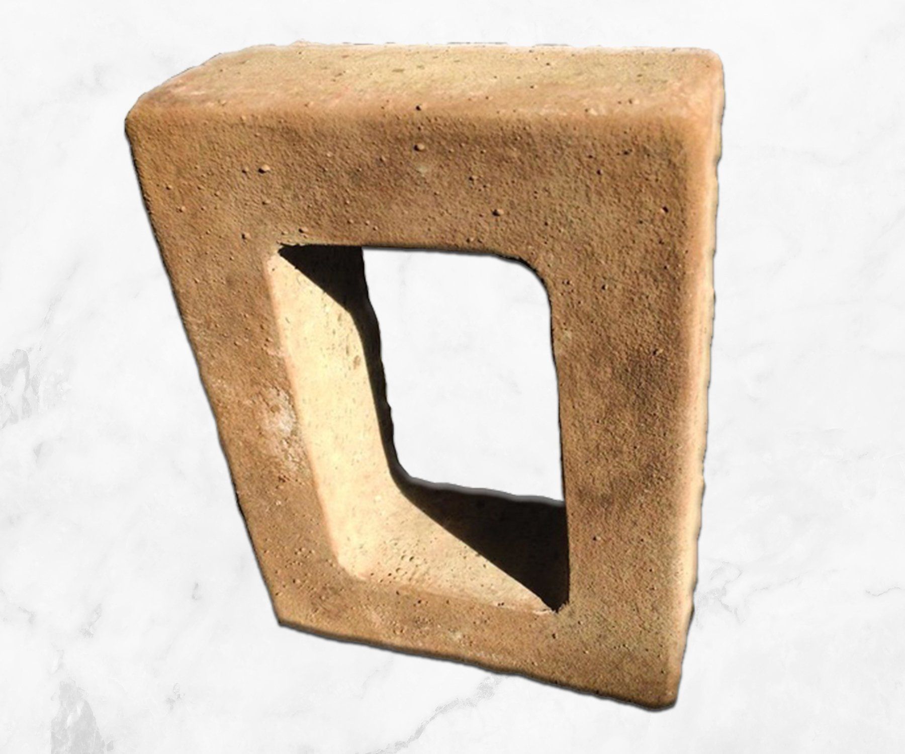 Beige triangular clay block with a square opening, isolated on white background