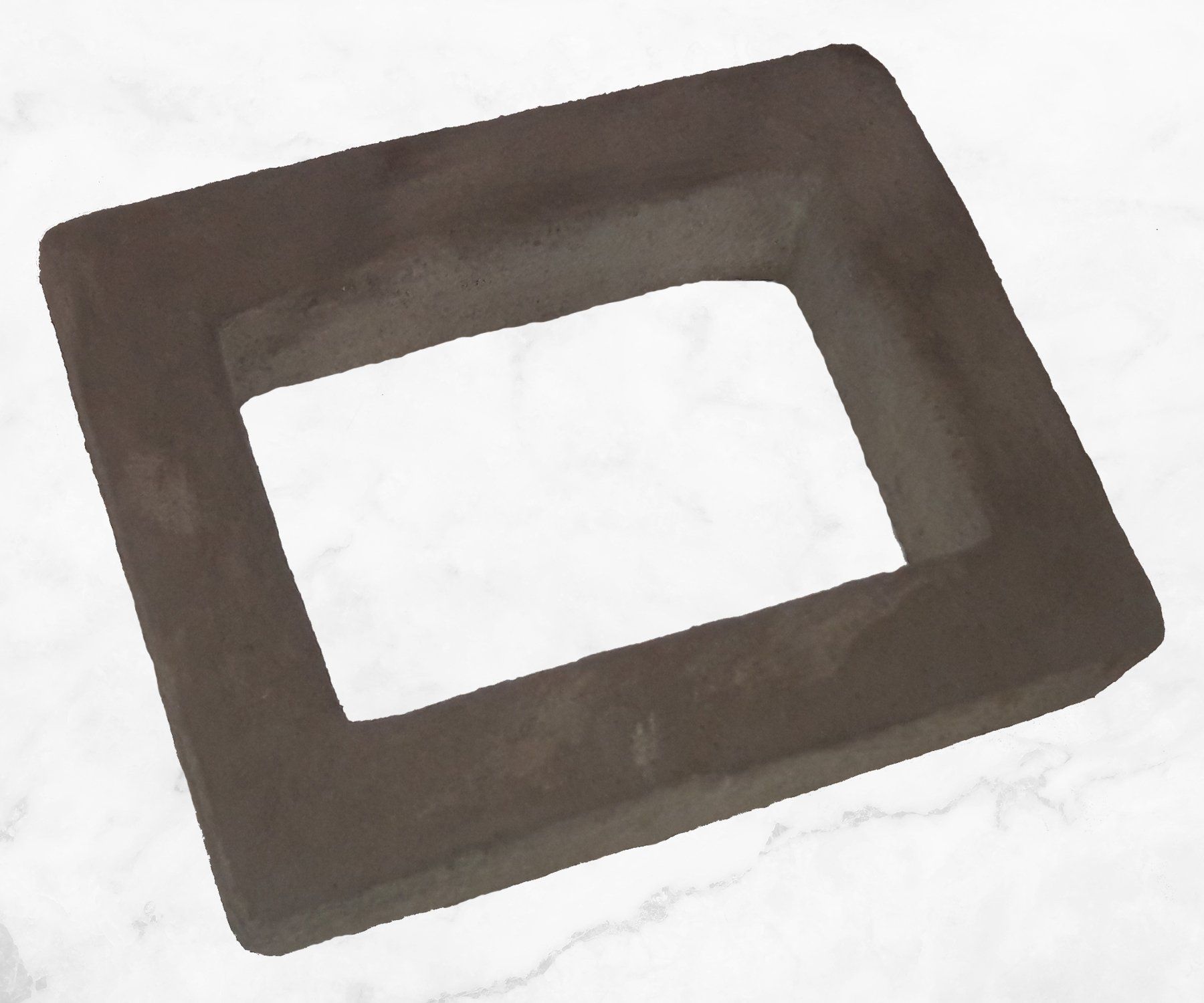 Brown rectangular rubber mat with a large cutout center on a white background