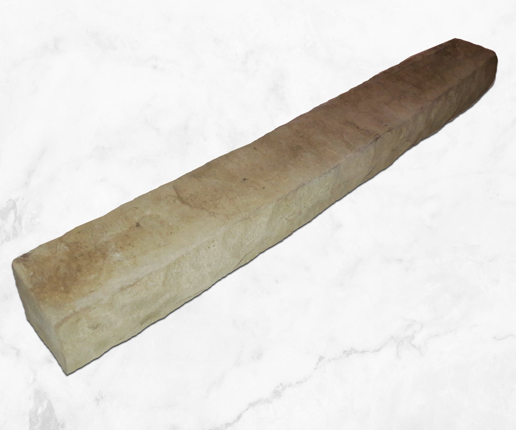 Long rectangular stone block with rough beige surface