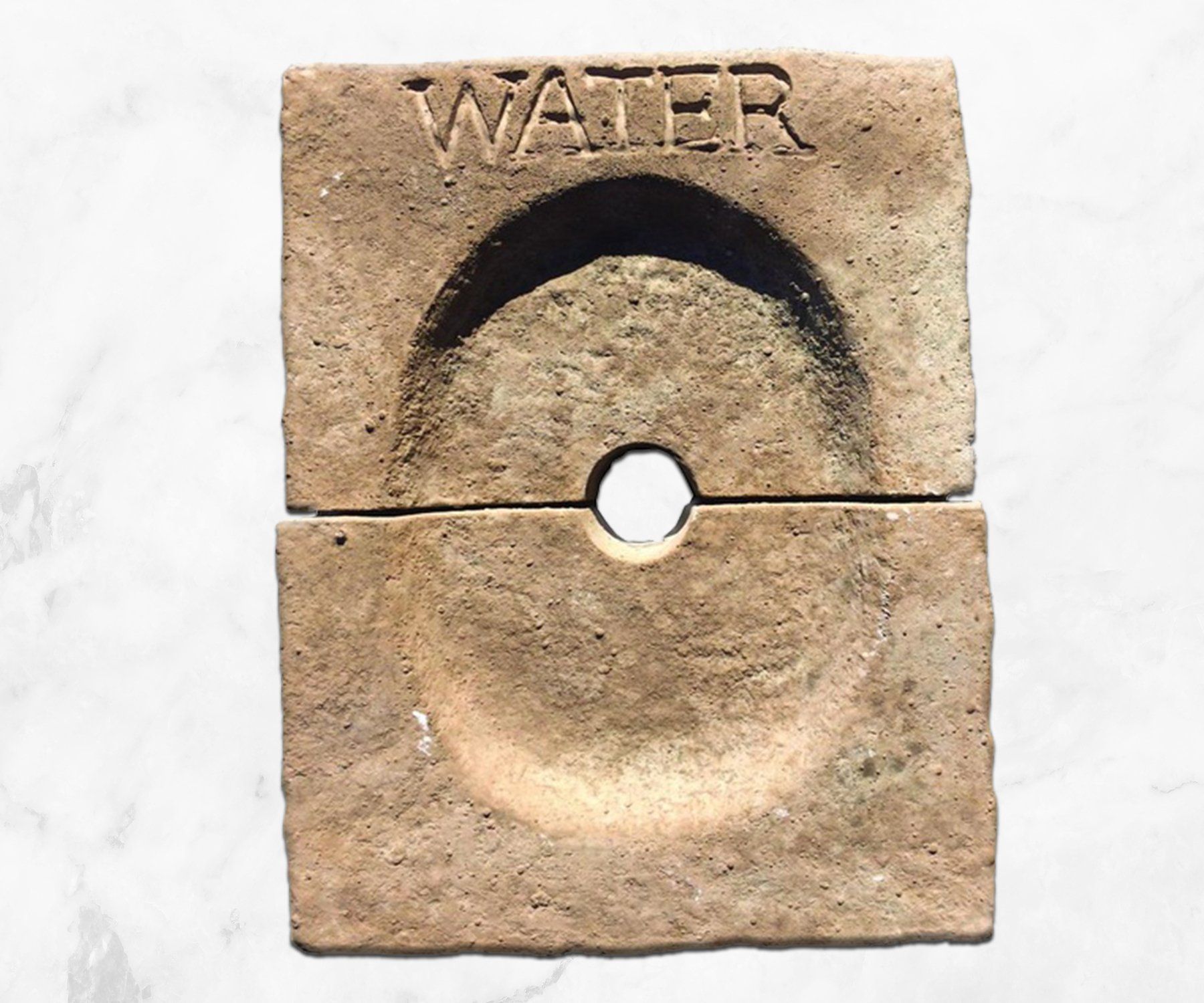 Beige square object labeled “WATER” with a circular hole and raised arc design