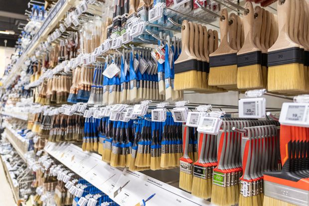Paint brushes on display in a store, various sizes and colors, organized on shelves with price tags. Paint brushes on display in a store, various sizes and colors, organized on shelves with price tags.