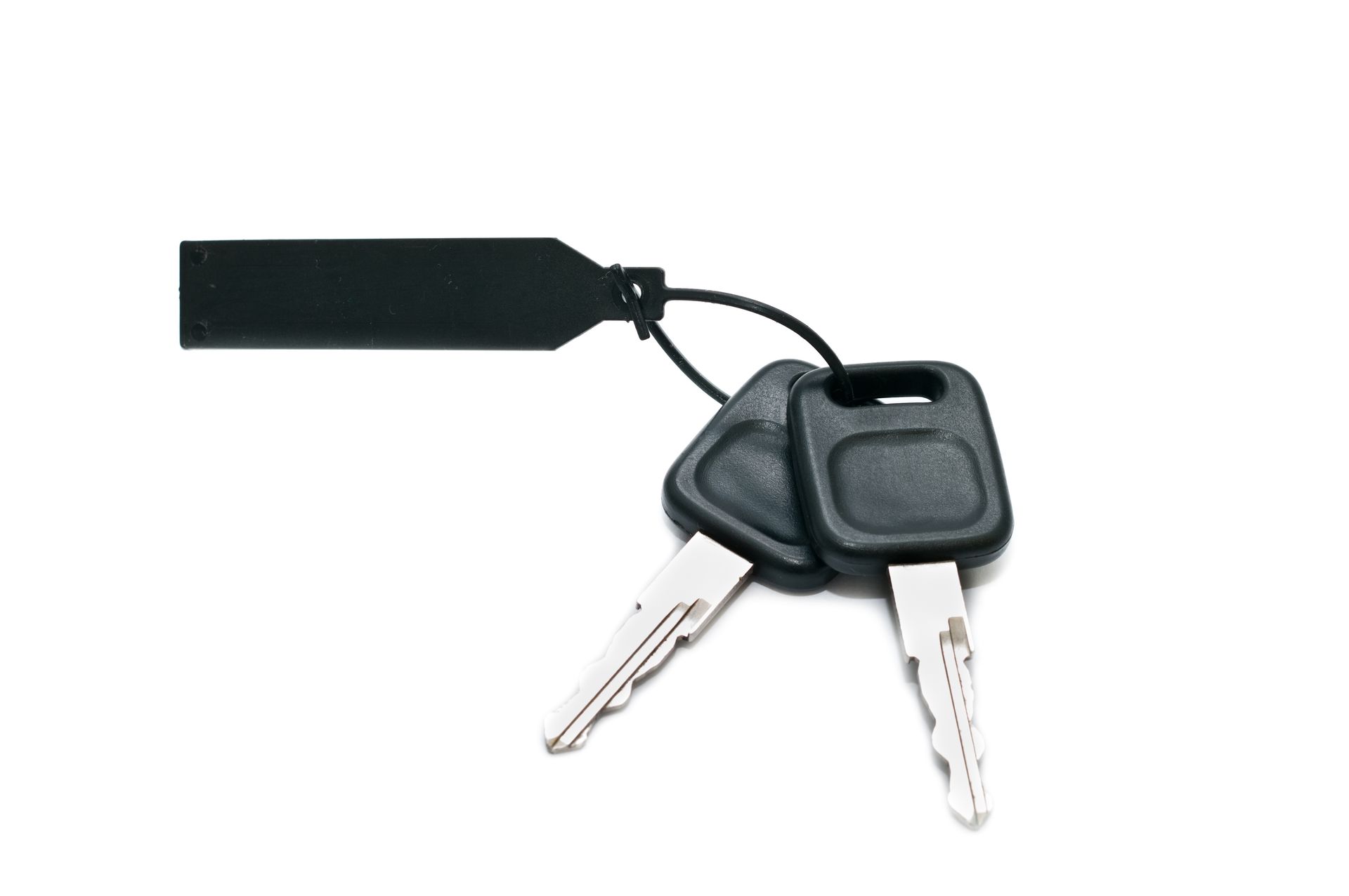 Hand passing car keys to another person, car in background.