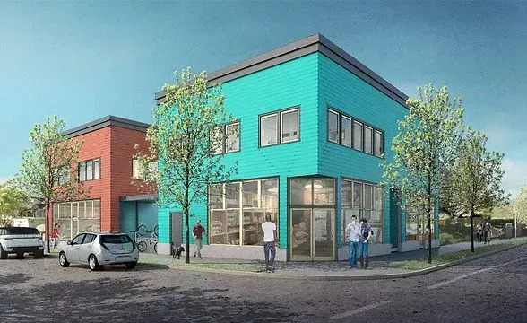 Two-story commercial buildings: turquoise and red, with large windows. People walking. Trees and parked car on street.