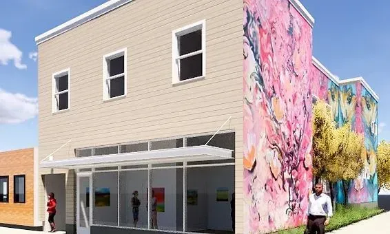 Building with art gallery and mural; people walking by.