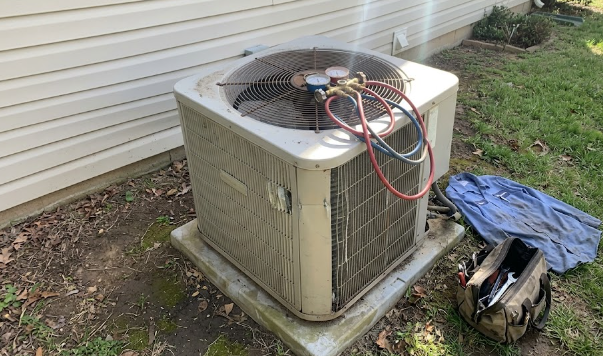 Friendly technician providing expert HVAC repair in Spokane WA outside a residential home.