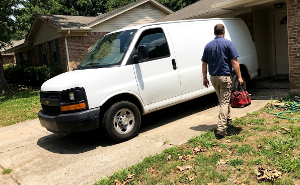 Spokane Heating and Cooling service van parked outside a local home for an AC repair visit.