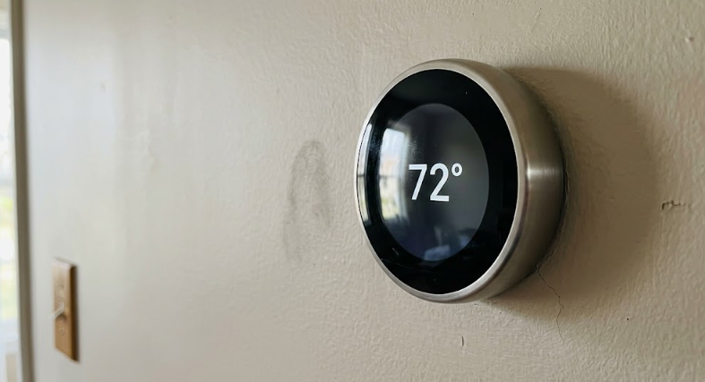 A modern smart thermostat installed on a wall keeping a Spokane home at a comfortable temperature.