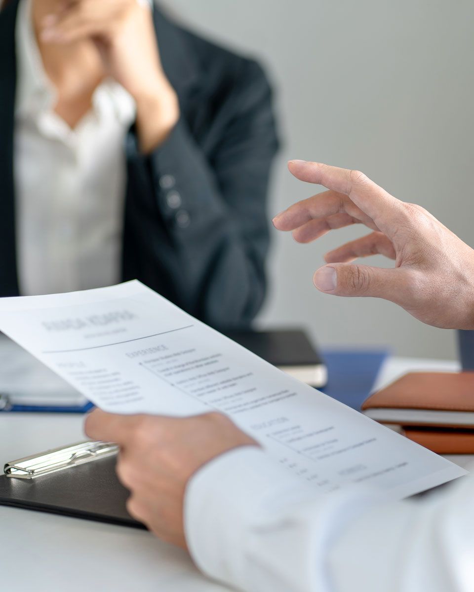 HR specialist reviewing workplace policies, training materials, and compliance documents