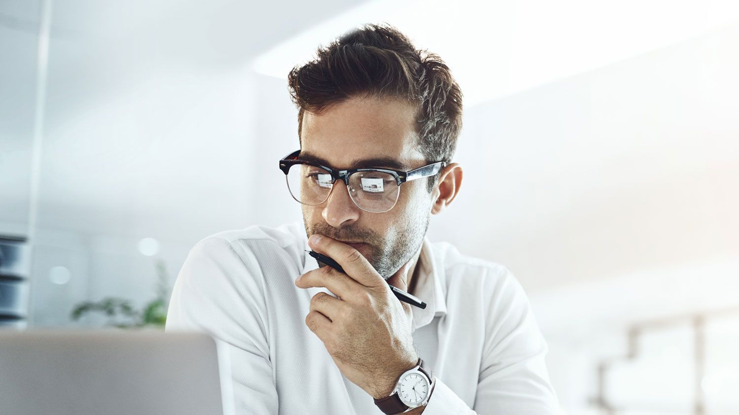 Small business owner reviewing employee benefits plan renewals and coverage options before open enrollment.