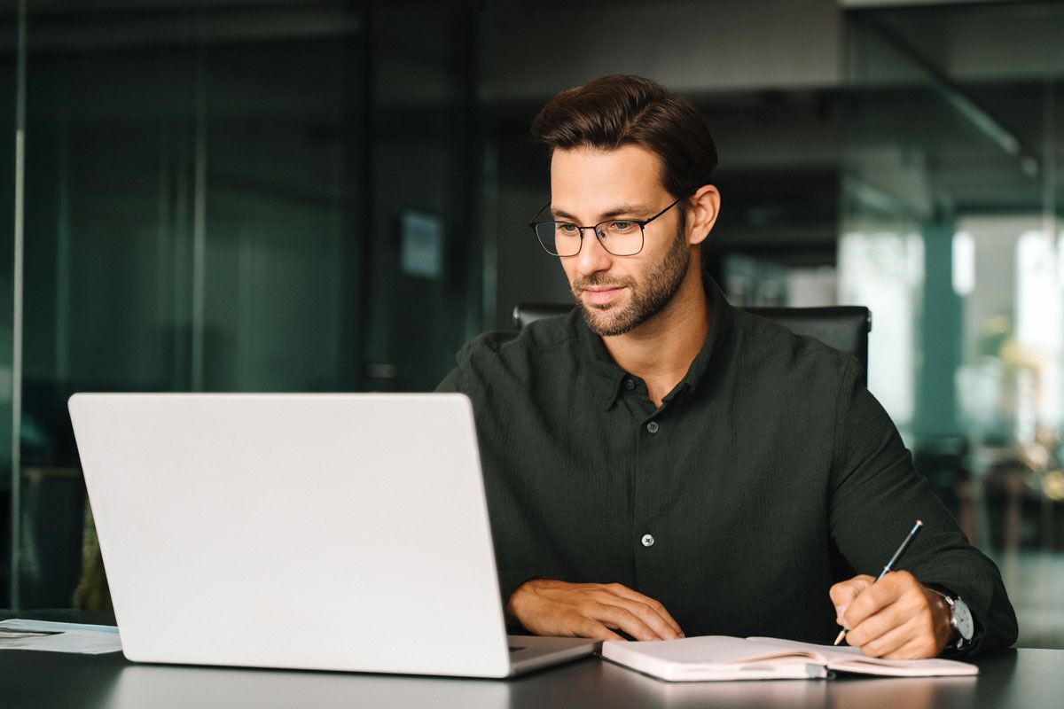 Manager reviewing workforce reports and timekeeping analytics on a laptop