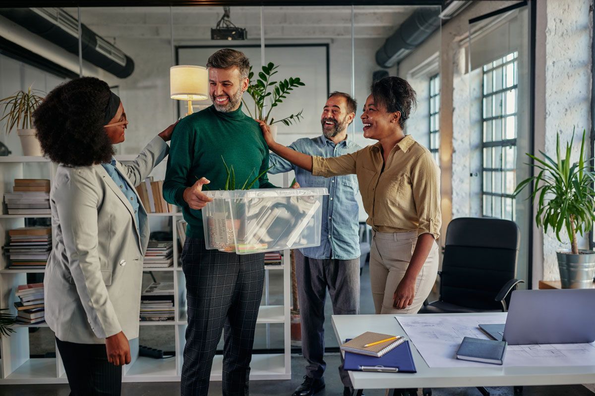 Employees welcoming a coworker back to the office through a return-to-work program