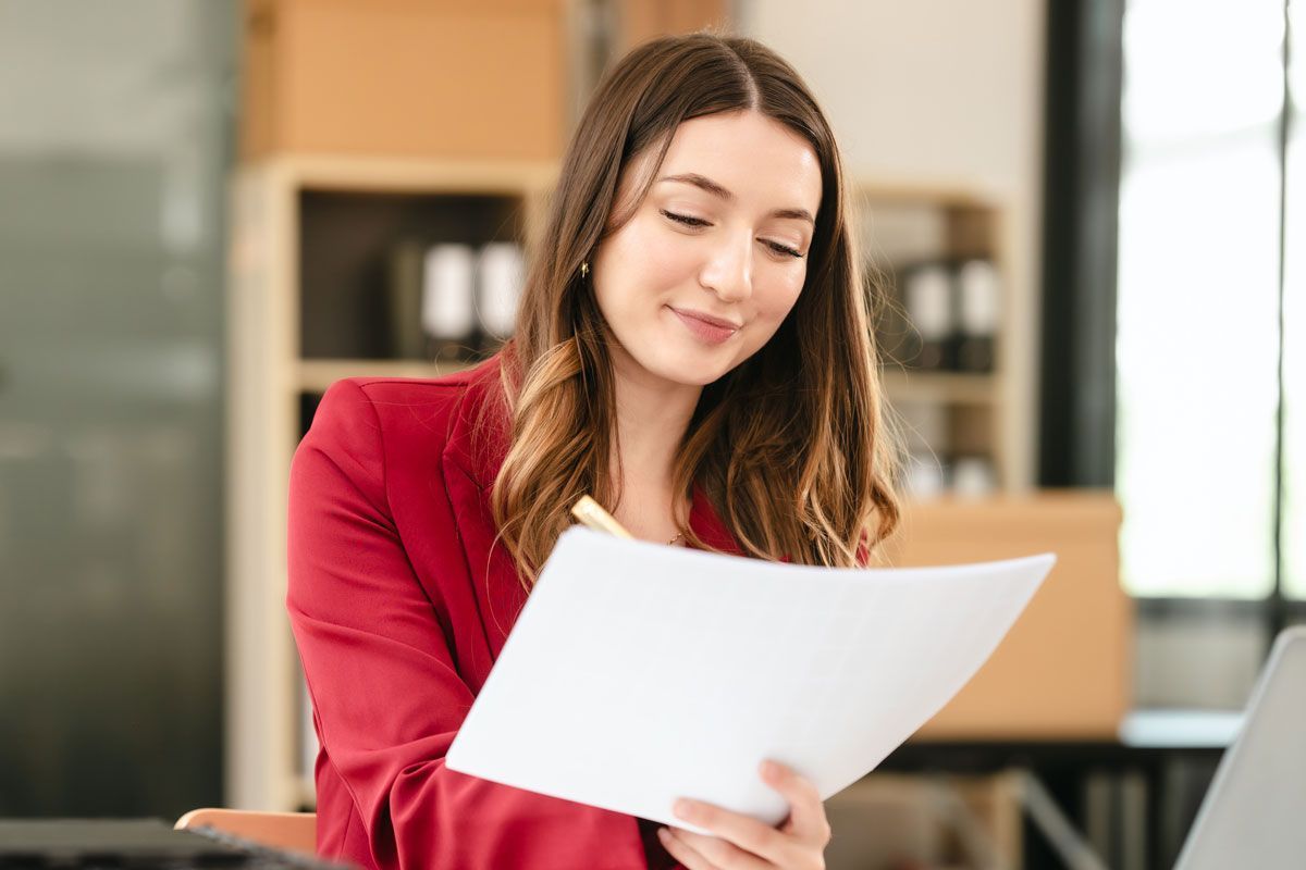 “Small business payroll professional reviewing employee payroll paperwork