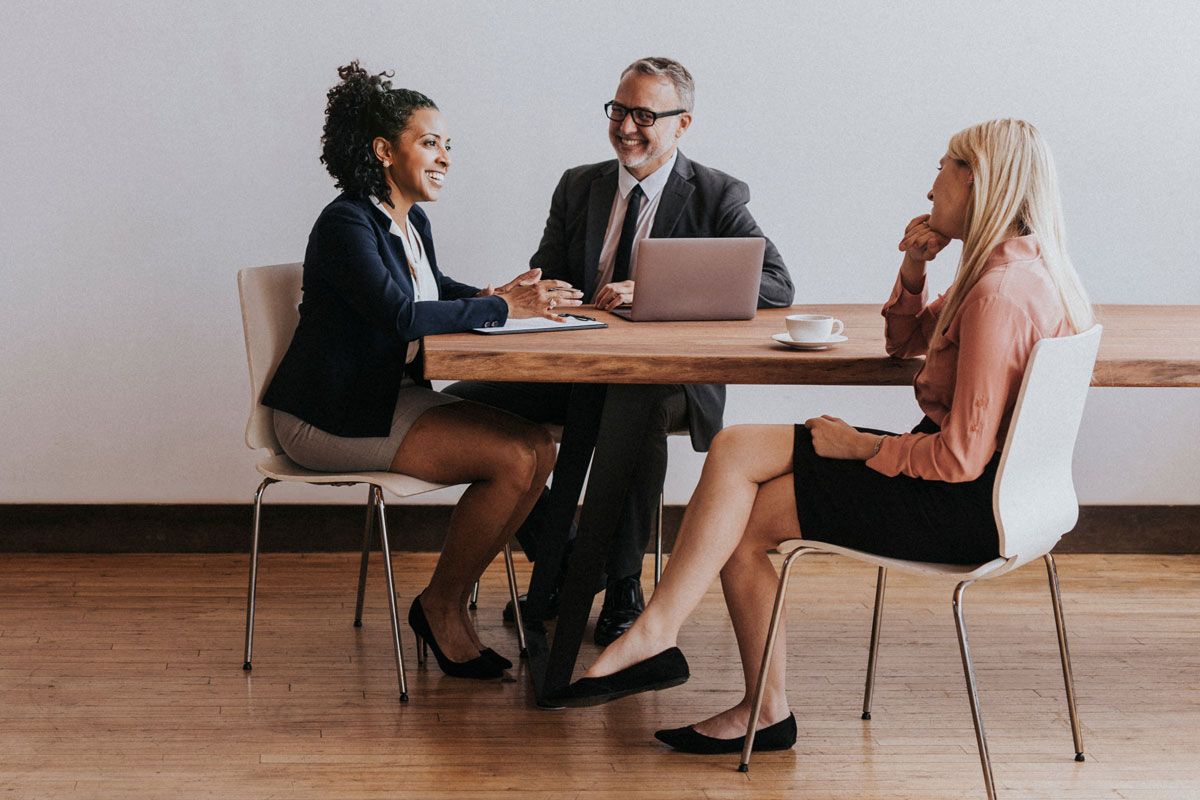 HR consultants meeting with a business owner about payroll and workforce management