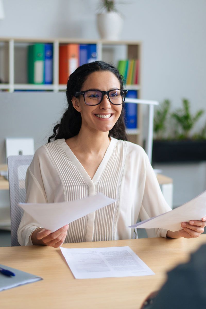 HR professional reviewing hiring documents for recruiting and onboarding support