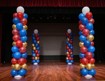 Balloon columns flanking a stage