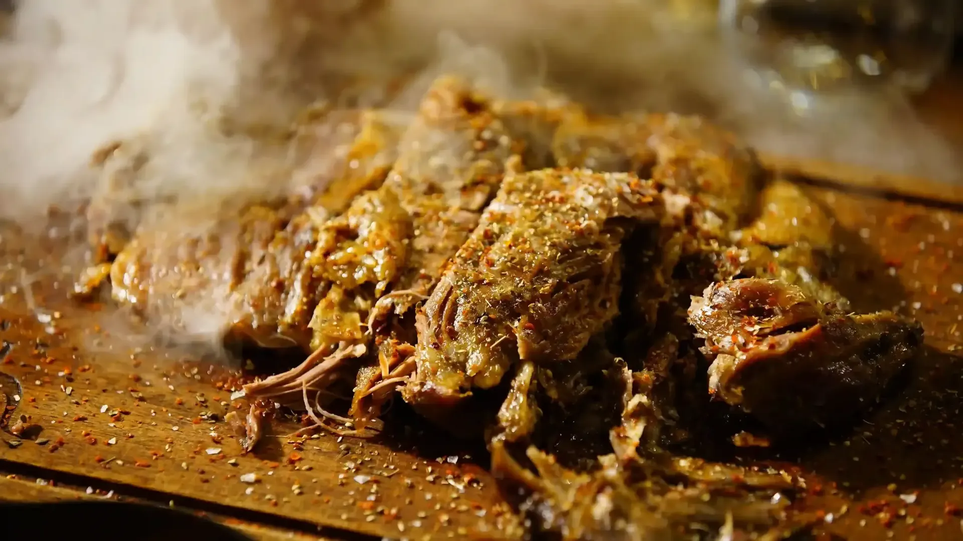 Close up view of sliced smoked pork ribs showing a clean bone separation and juicy meat texture.