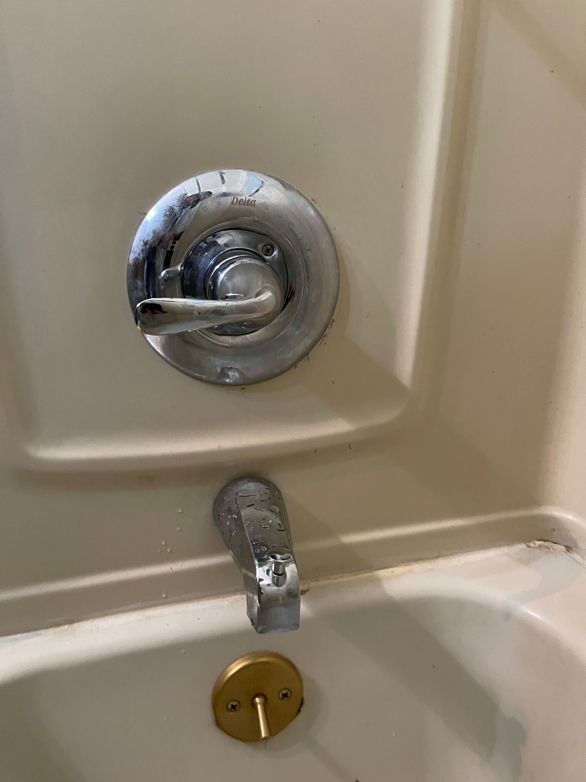 A man and a woman are fixing a sink in a bathroom.