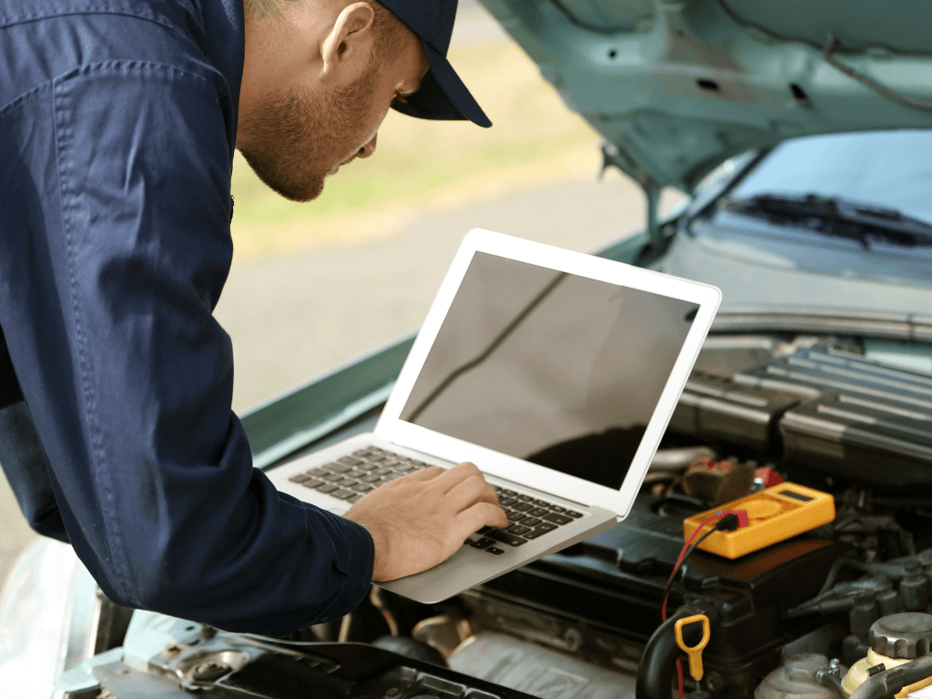 a mechanic doing a diagnostic test on a car