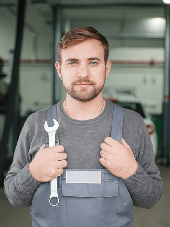 a picture of a professional mechanic holding a wrench