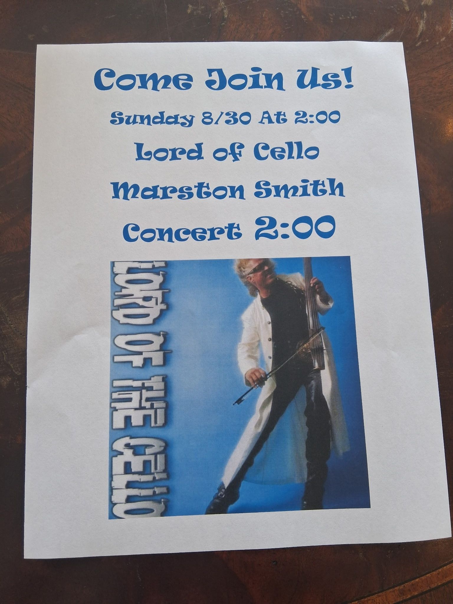Retro concert poster with blue text, blue background, and a man posing with a guitar-like prop, “Come Join us!”